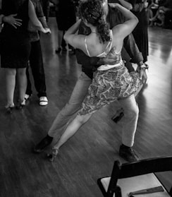 People are dancing tango in a ballroom.