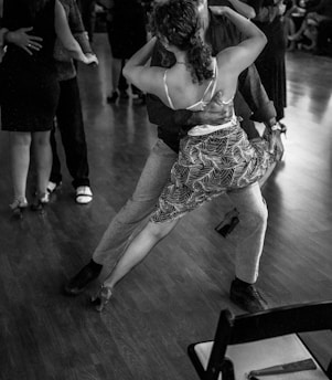 People are dancing tango in a ballroom.
