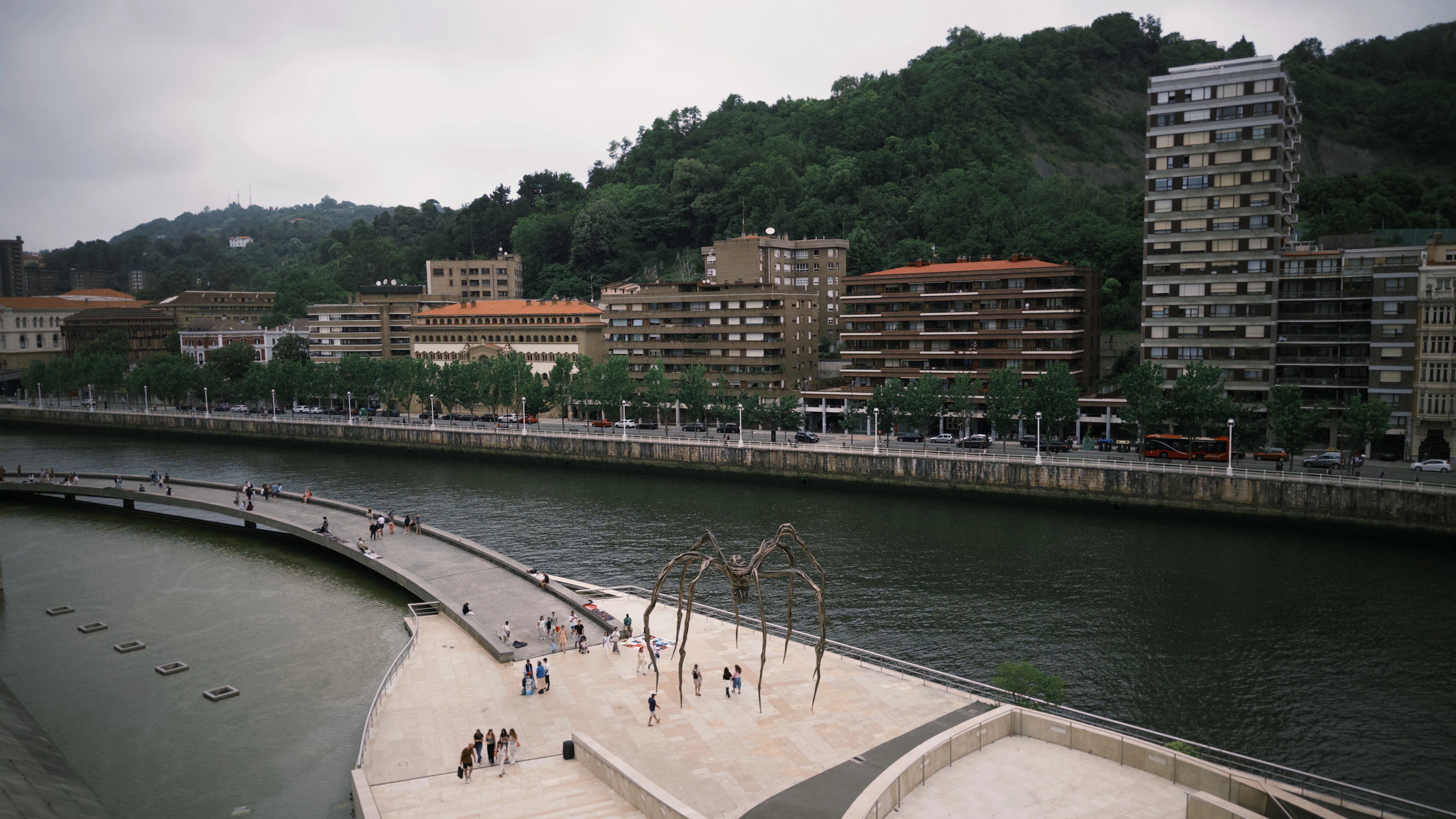 The riverside walk in Bilbao with the giant bronze spider standing on the terrace above the Nervion