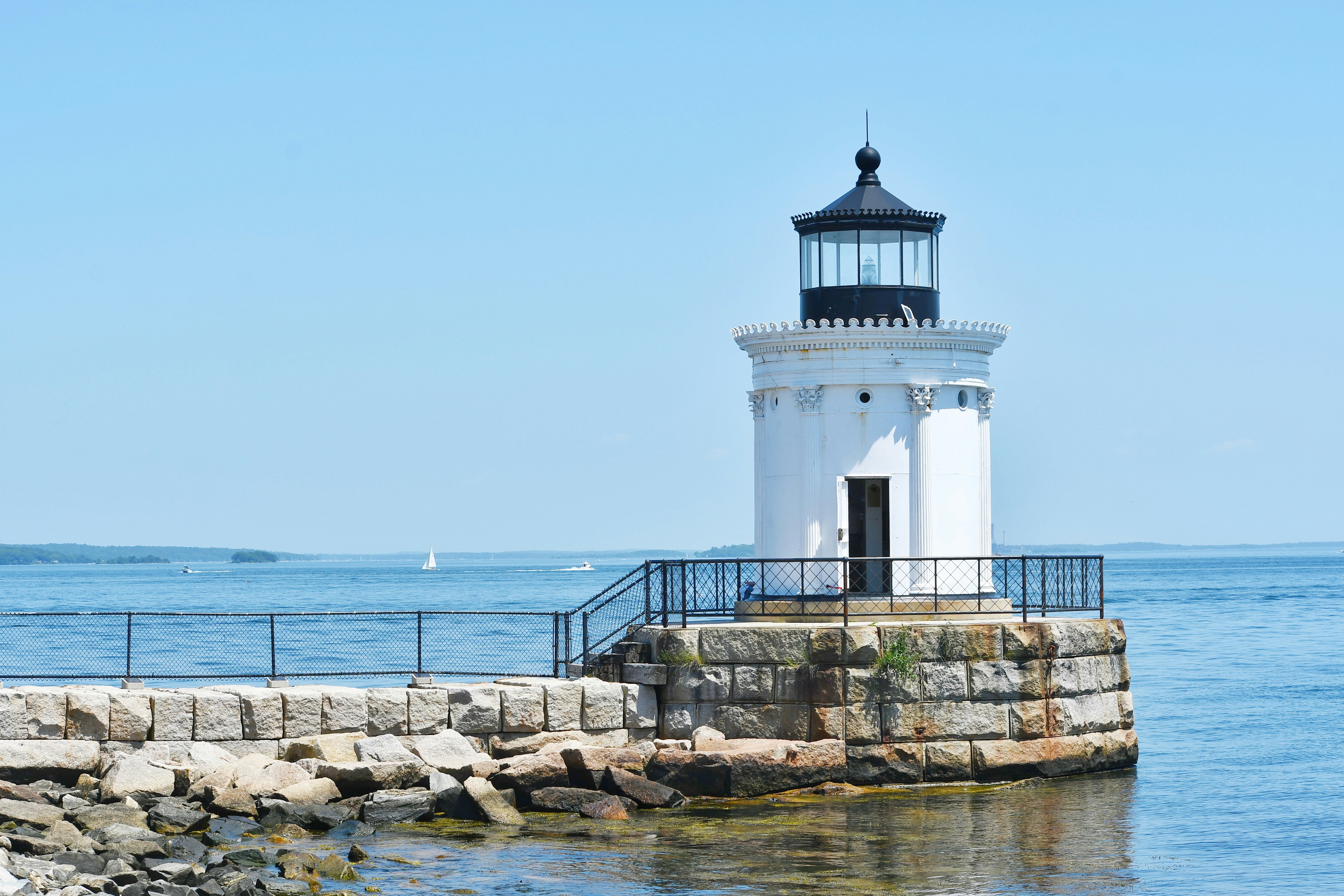 A lighthouse stands proudly on a seaside dock.