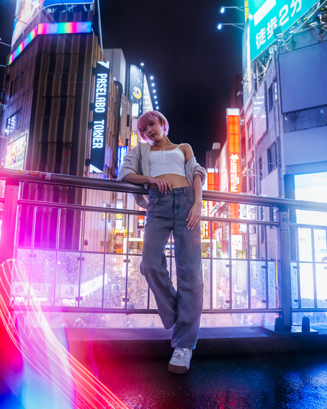 Street-culture editorial at night — the backdrop of a wallet that lives where they live