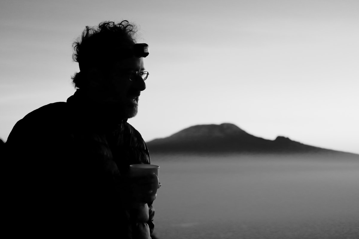 Man enjoys the view of a distant mountain