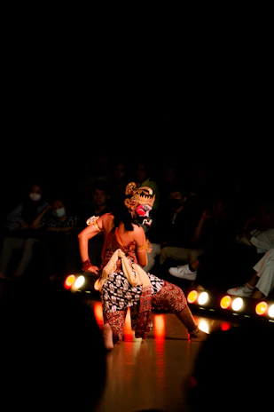 A dancer performs in a traditional, ornate costume.