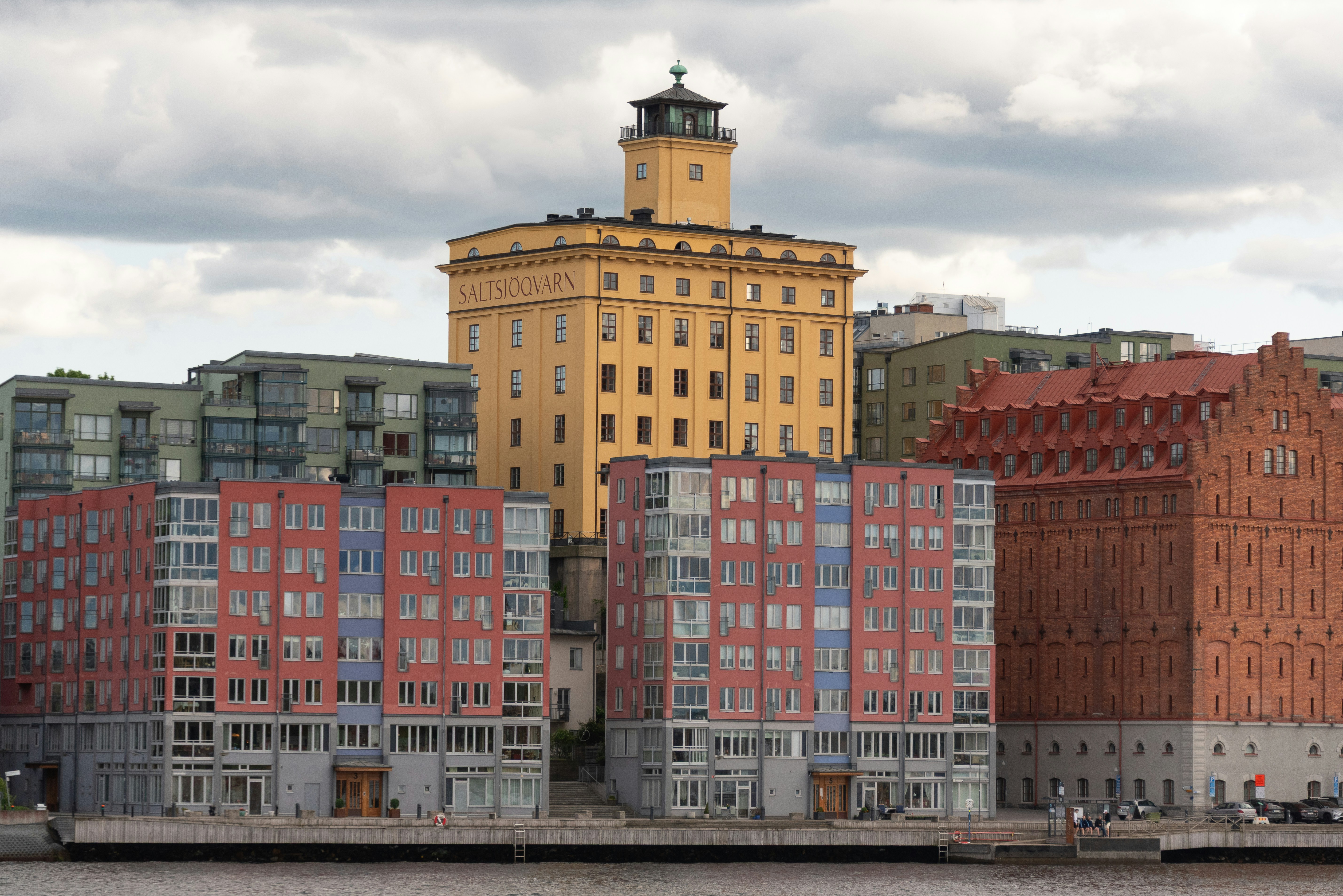 Modern buildings stand along the waterfront.
