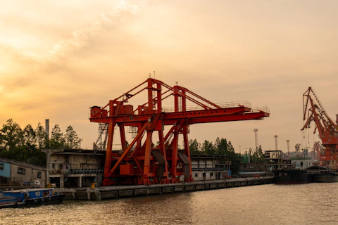 Cranes stand over water at a port.