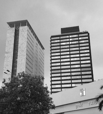 Two skyscrapers stand tall under a gray sky.