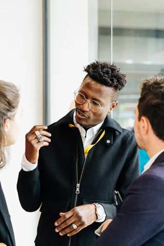 Three people are engaged in a friendly conversation.
