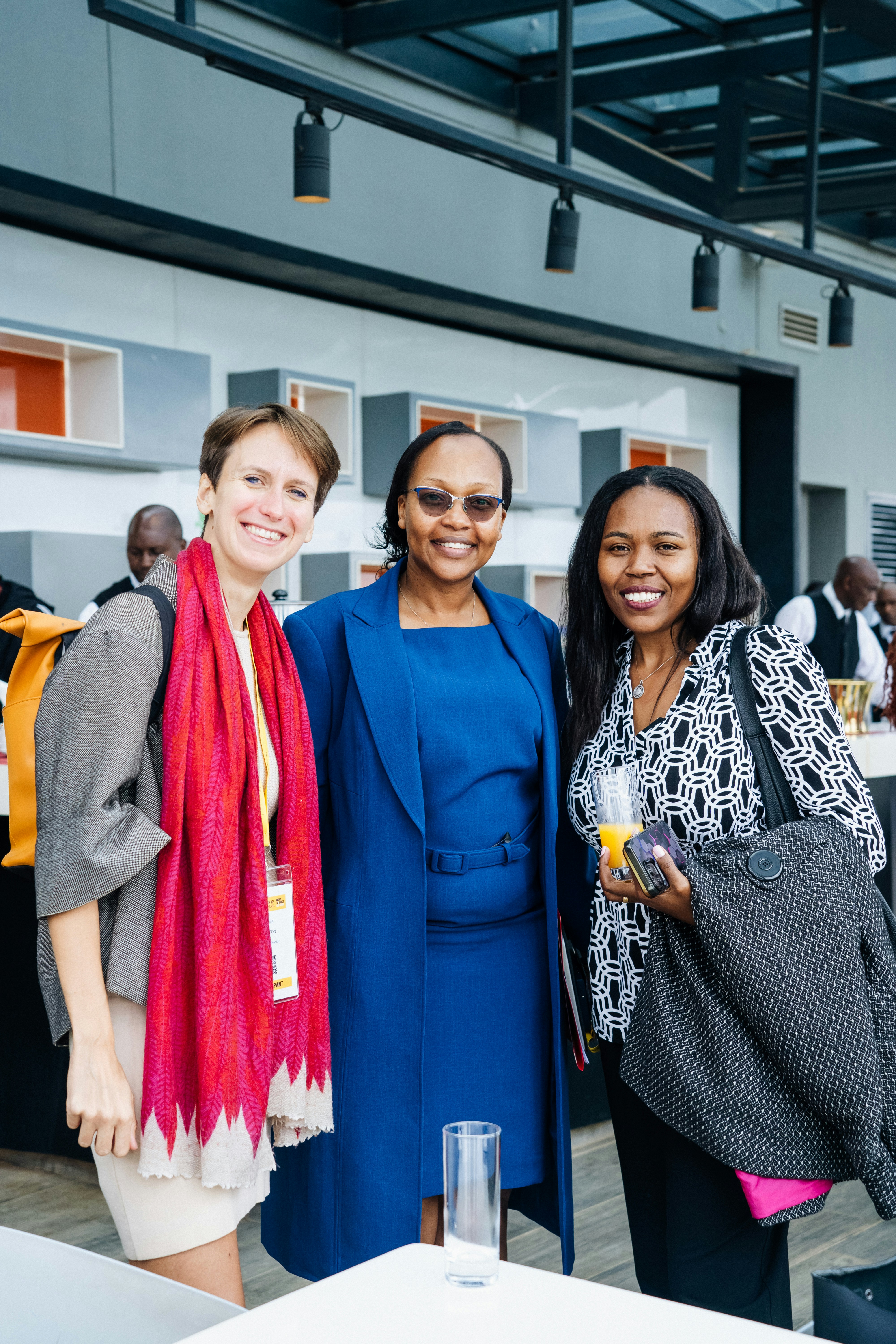Three smiling women pose for a photograph
