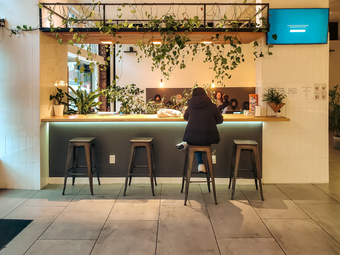 A guest sitting at the counter of a modern store