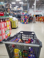 Shopping cart filled in a large grocery store.