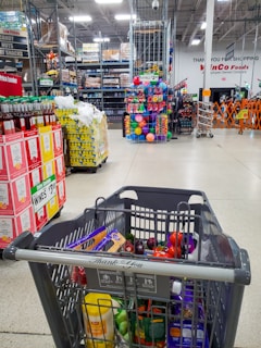 Shopping cart filled in a large grocery store.