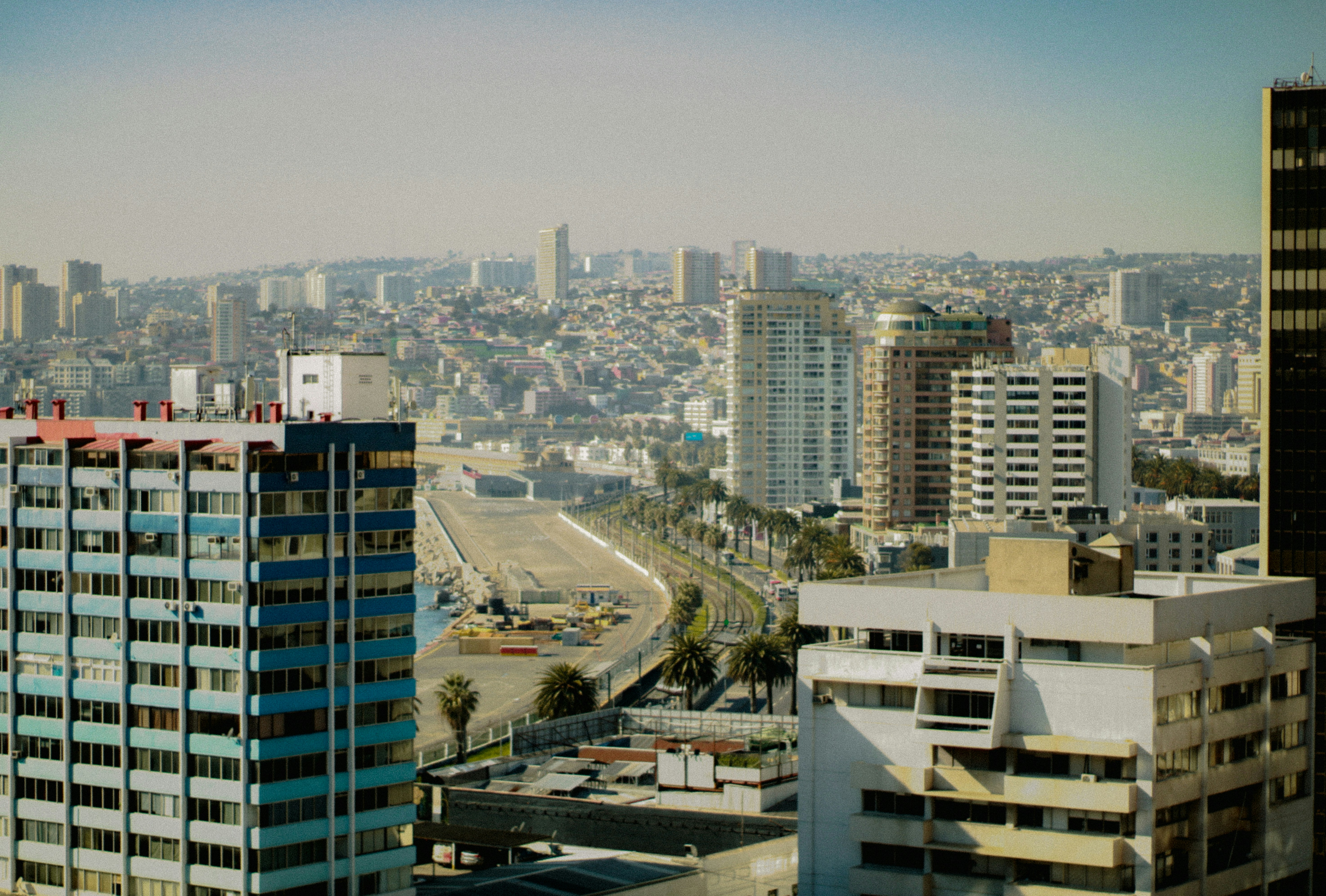 Cityscape filled with buildings under a clear sky.