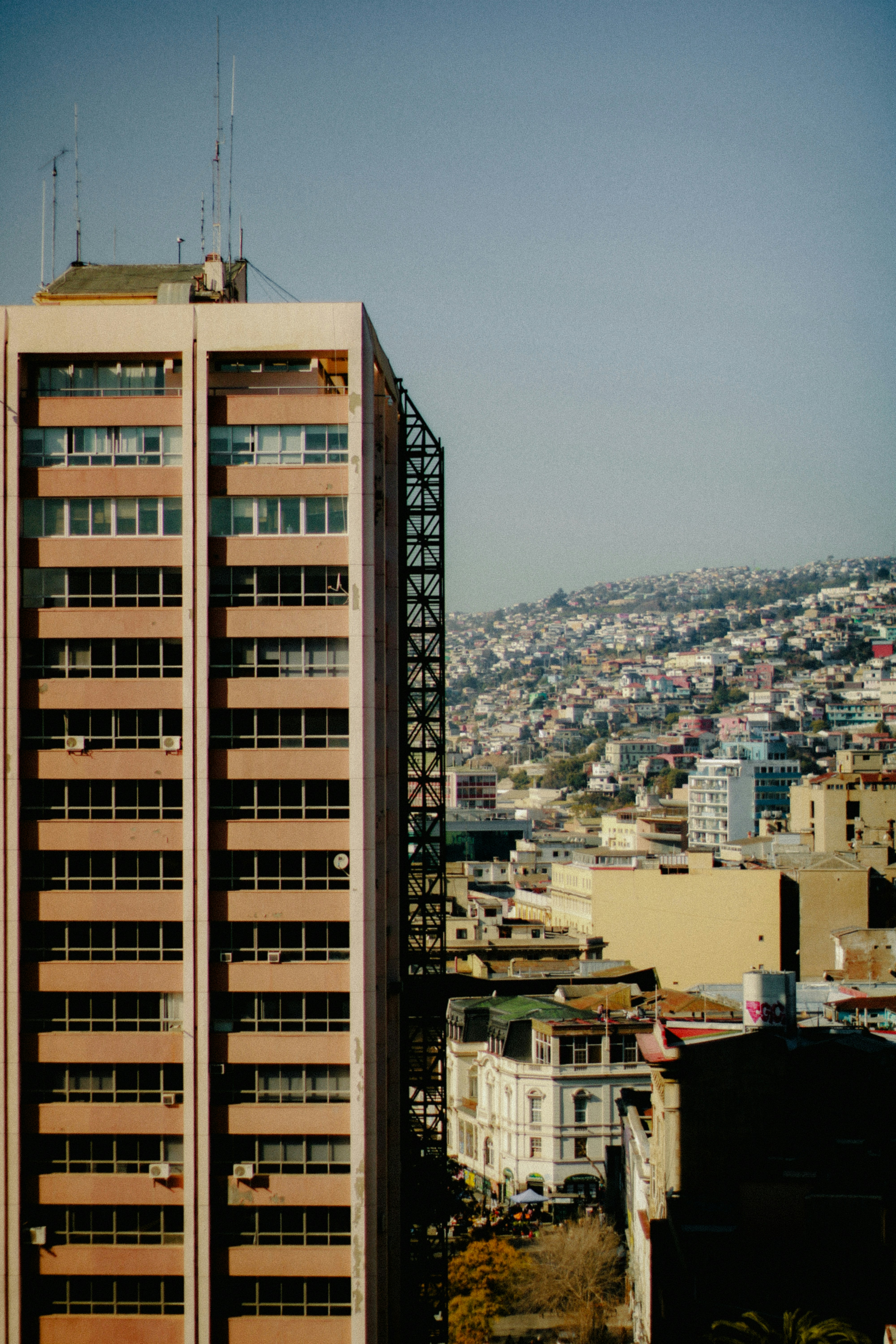 A tall building towers over a crowded city.