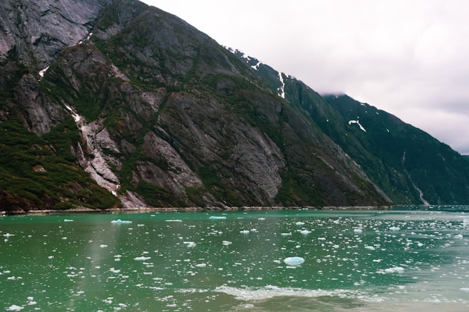 A glacial lake reflects rugged mountains.