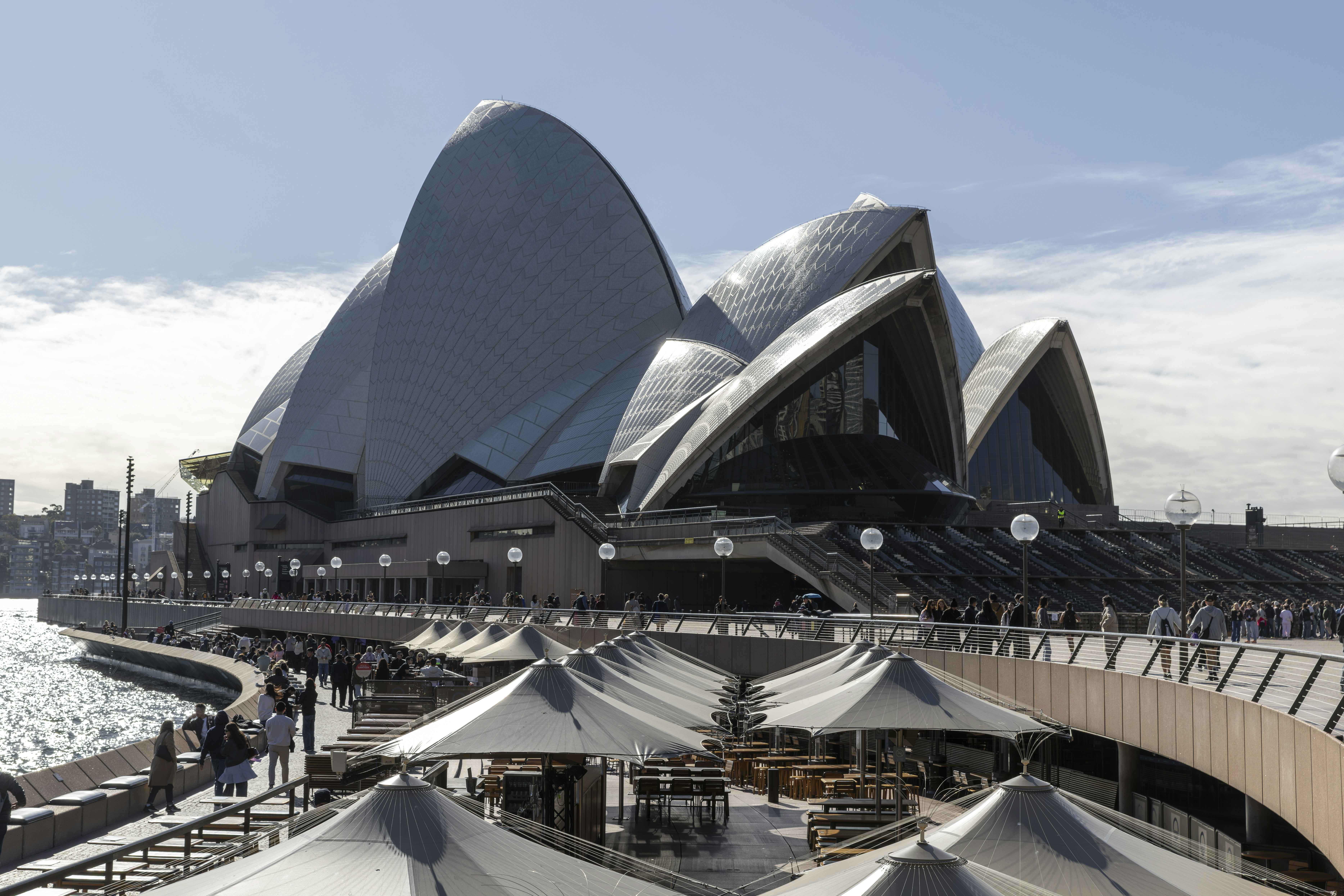 Sydney opera house sits by the water.