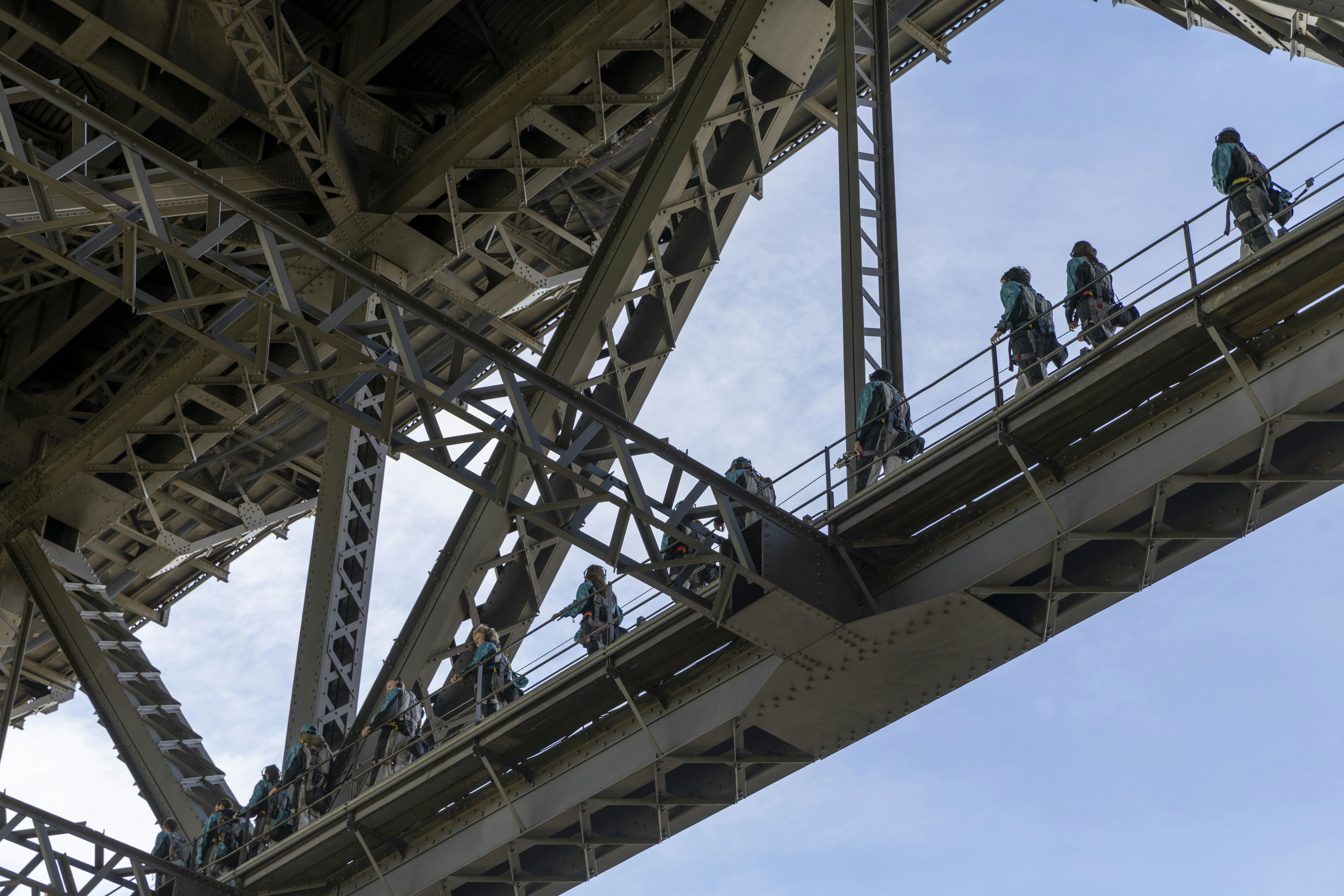 Workers walk on the bridge's structure.