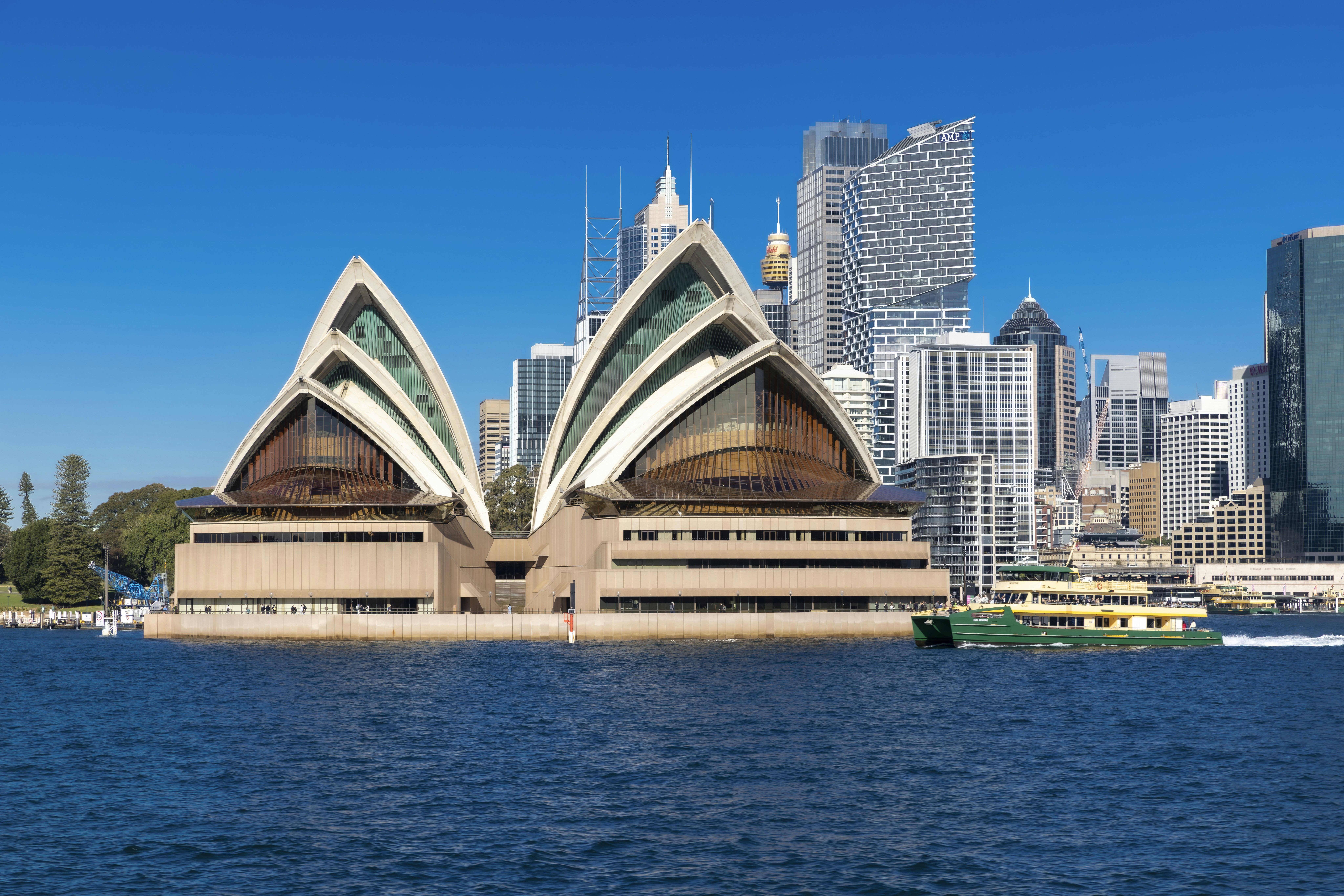 Sydney opera house overlooks the water and city.