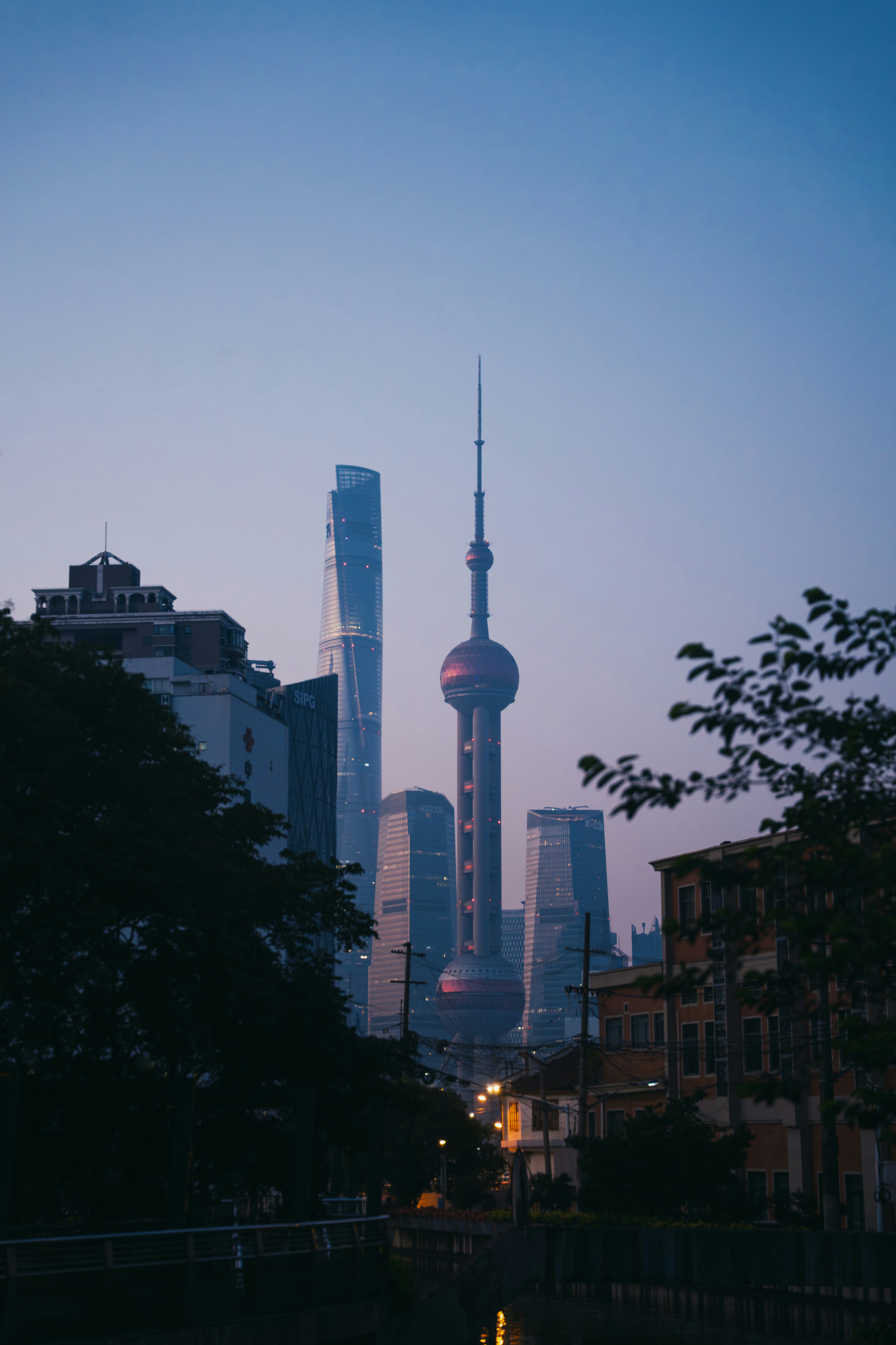 Shanghai's skyline stands tall at dusk.