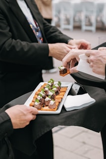 People are serving appetizers at an event.