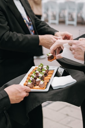 People are serving appetizers at an event.