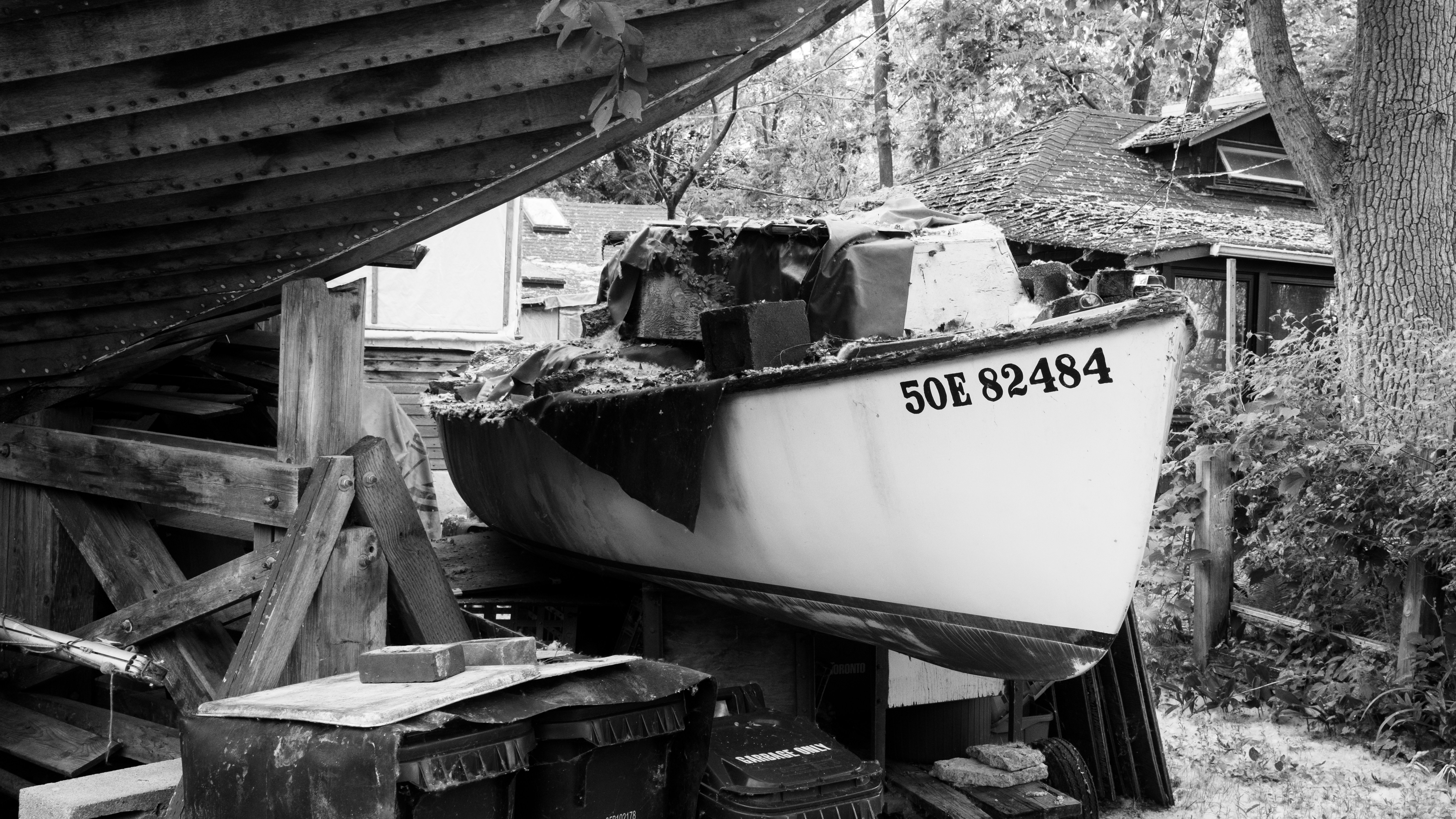 An old boat rests on wooden supports.