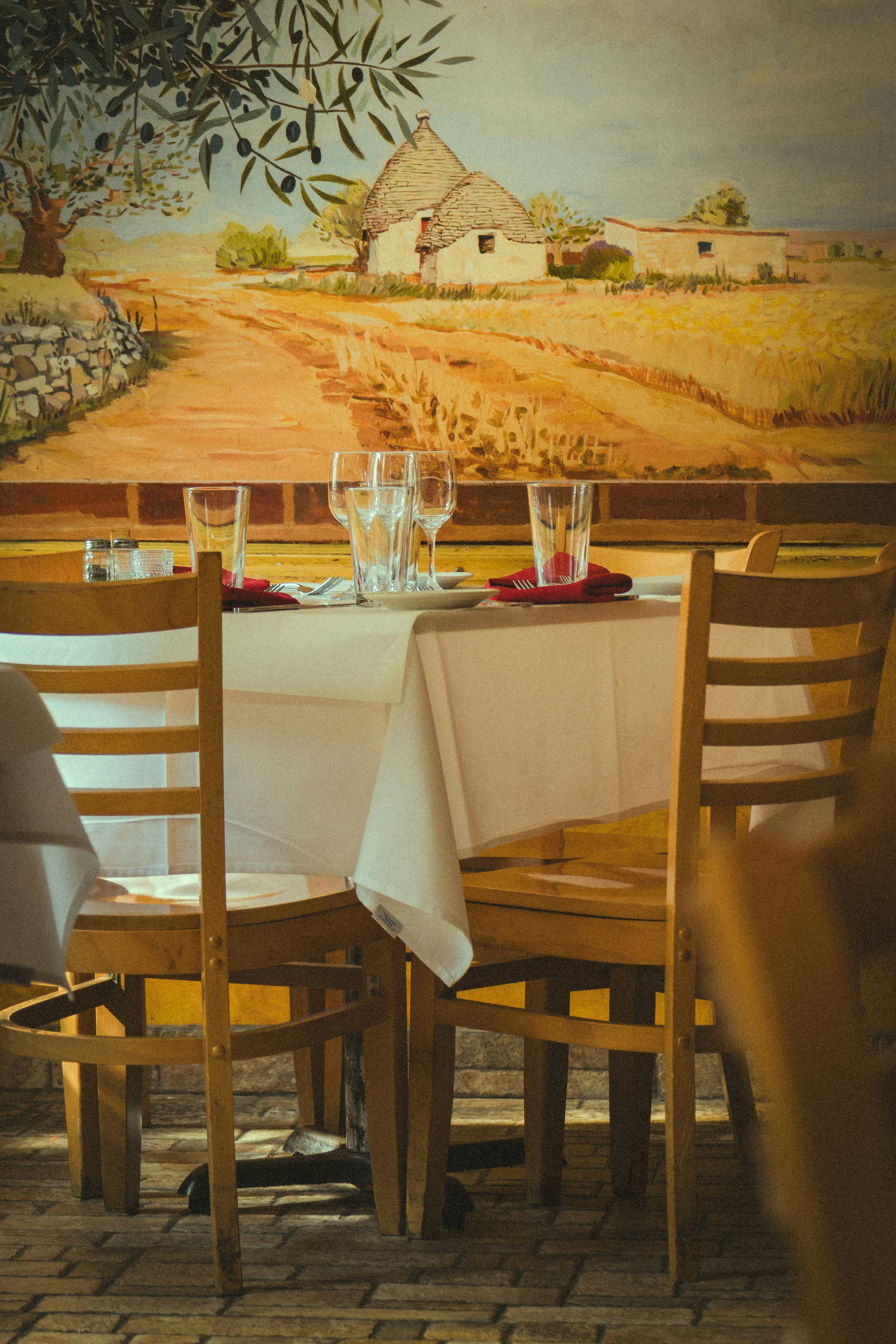 A table is set in a rustic italian restaurant.