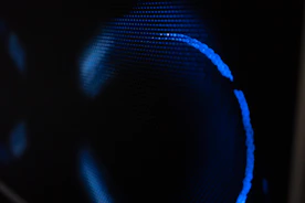 Blue light glows against a dark background.
