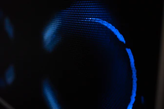 Blue light glows against a dark background.