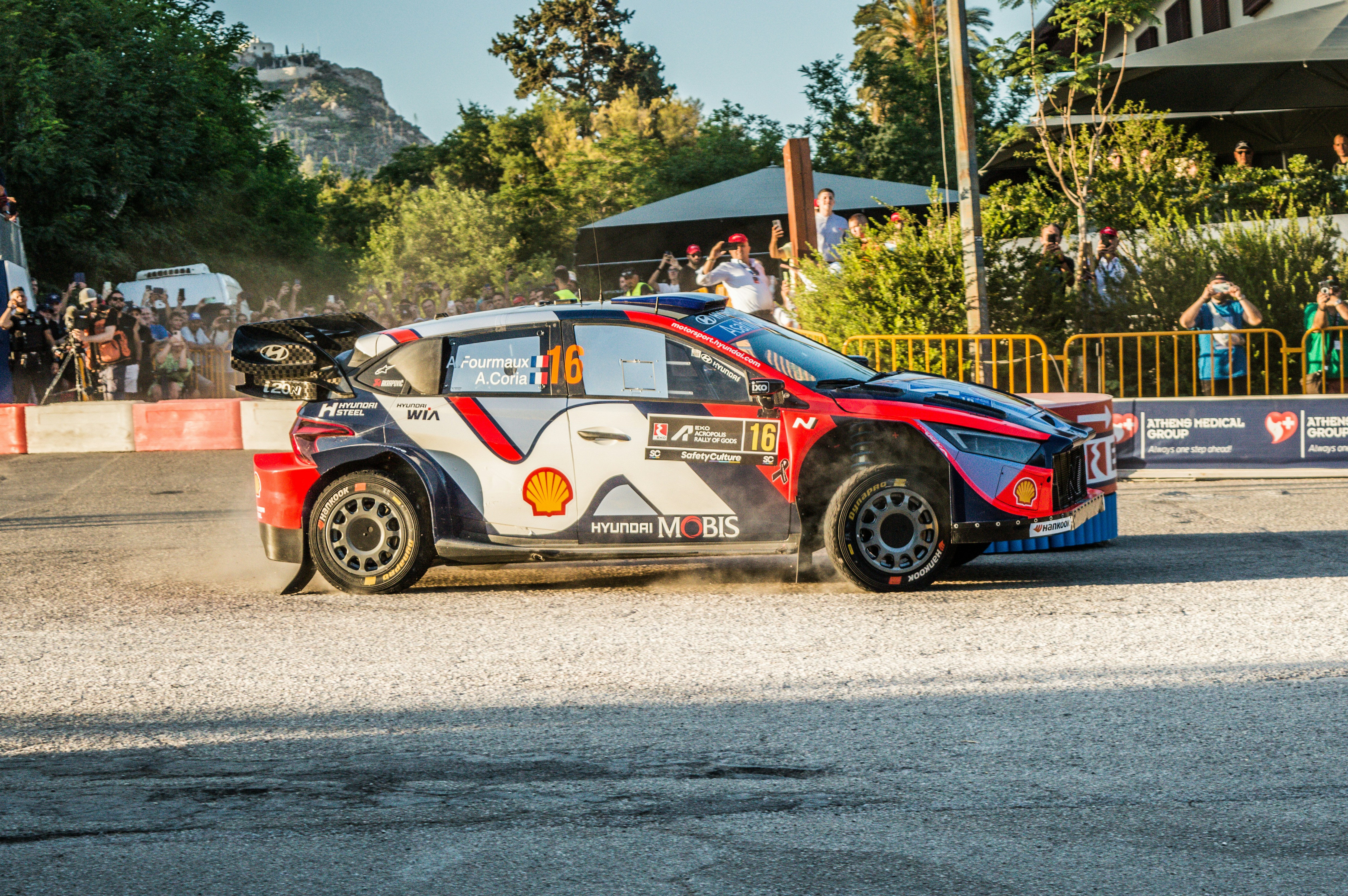 A race car speeds down a dirt road.
