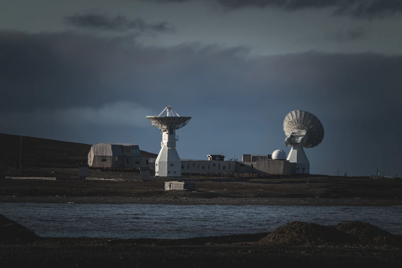 Satellite dishes against a dramatic sky