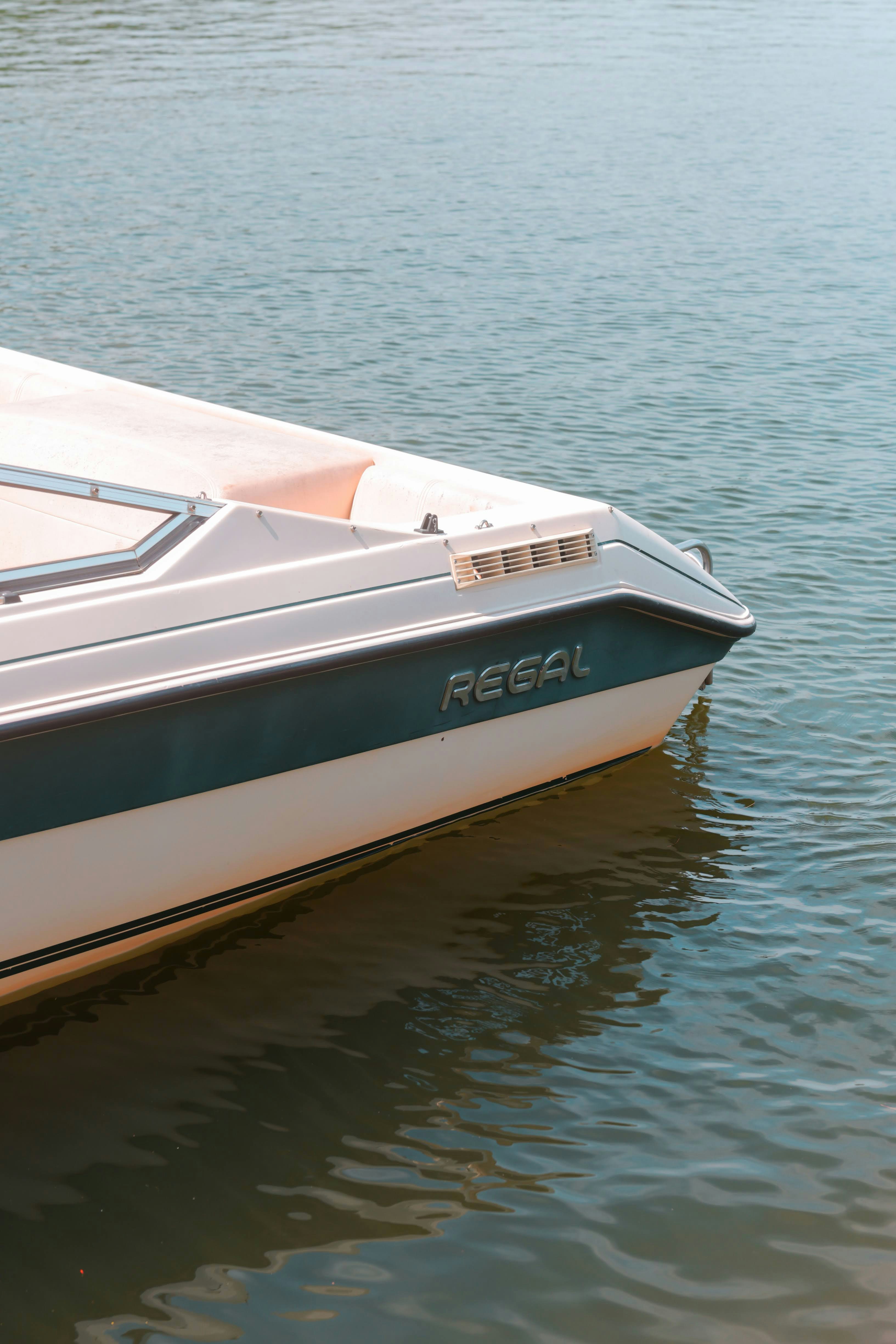A regal boat floats peacefully on the water.