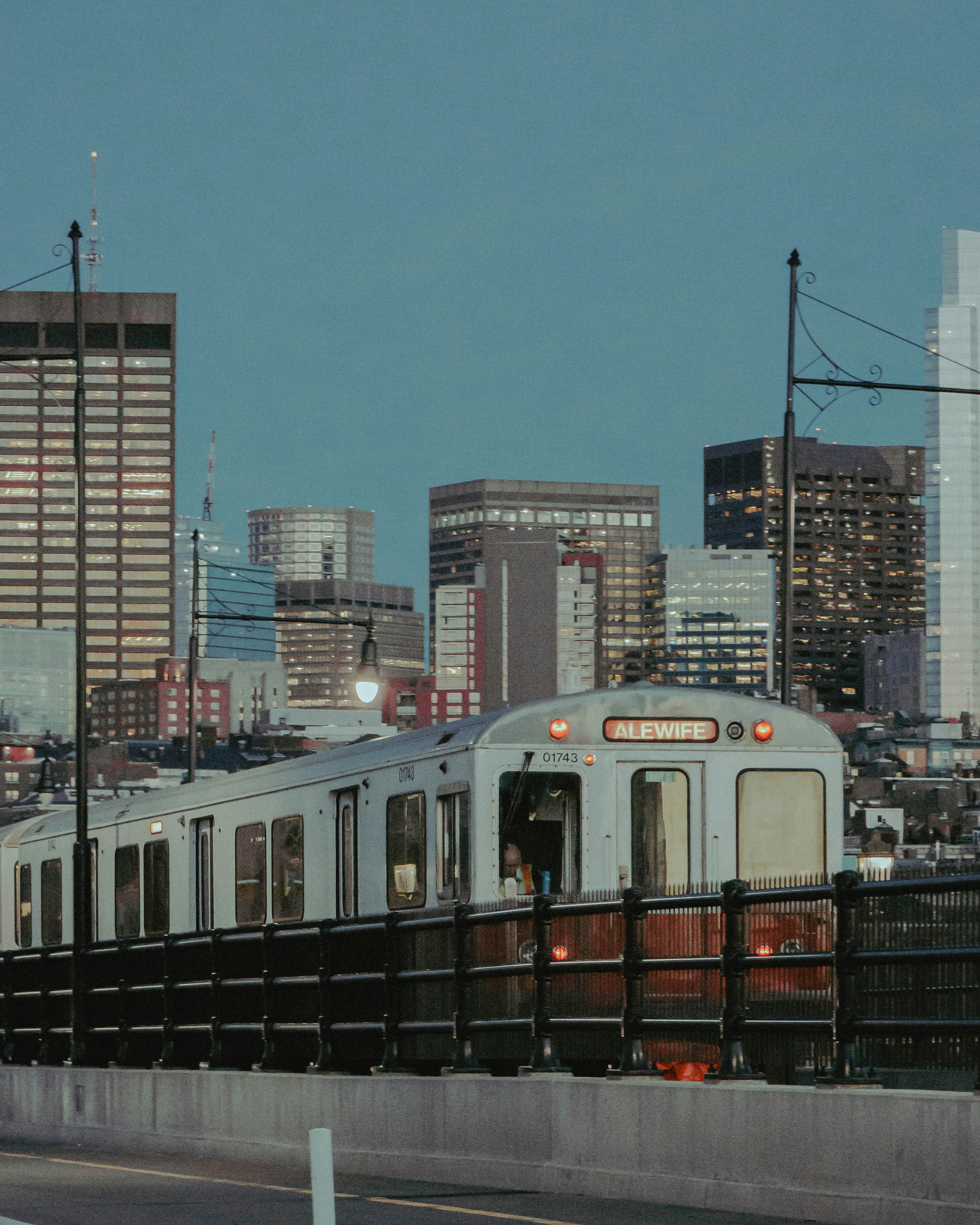 A train rides along with a city skyline.