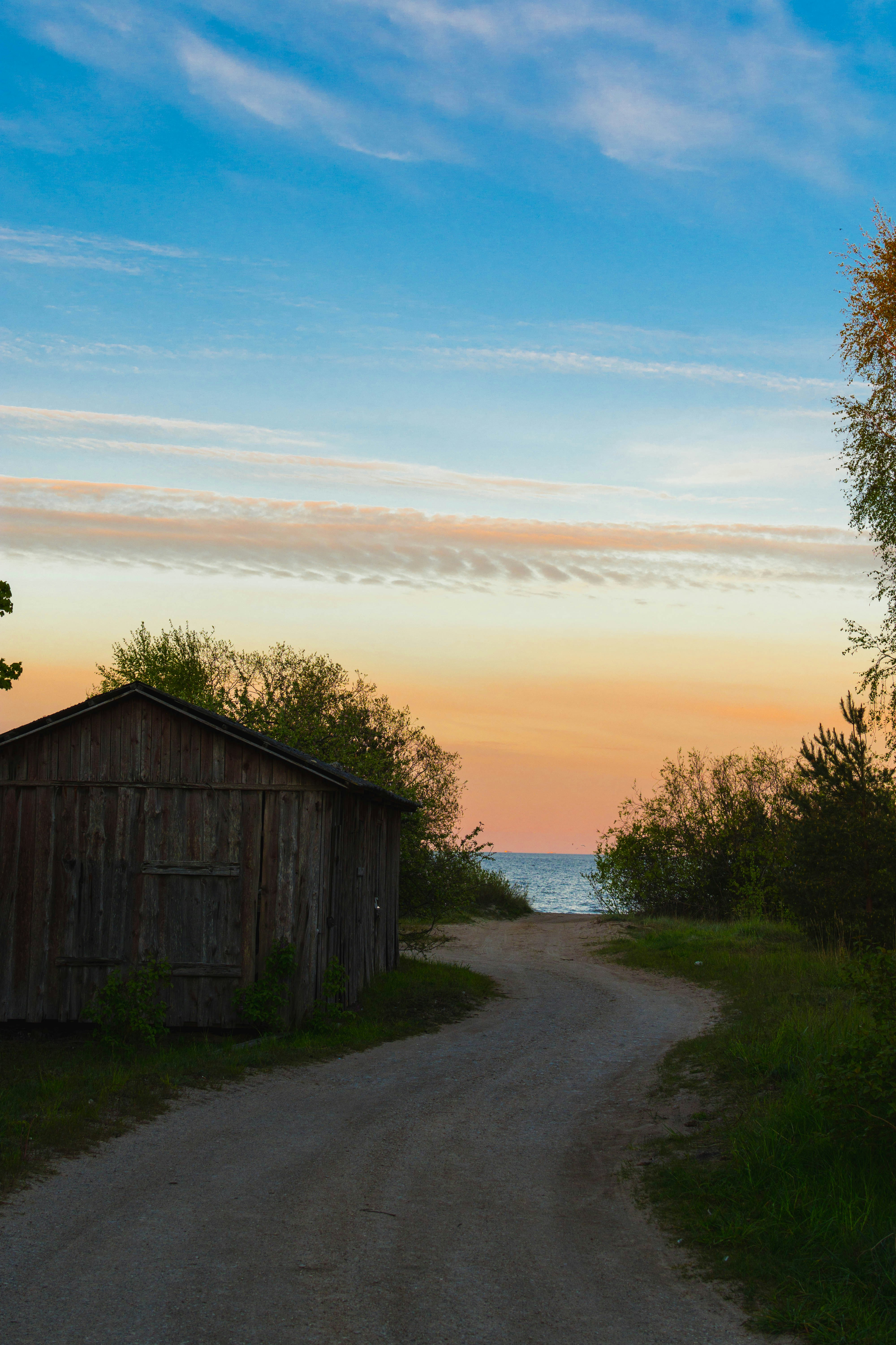 A winding road leads to a serene sunset.
