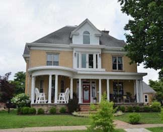 A stately, two-story house with a large porch.