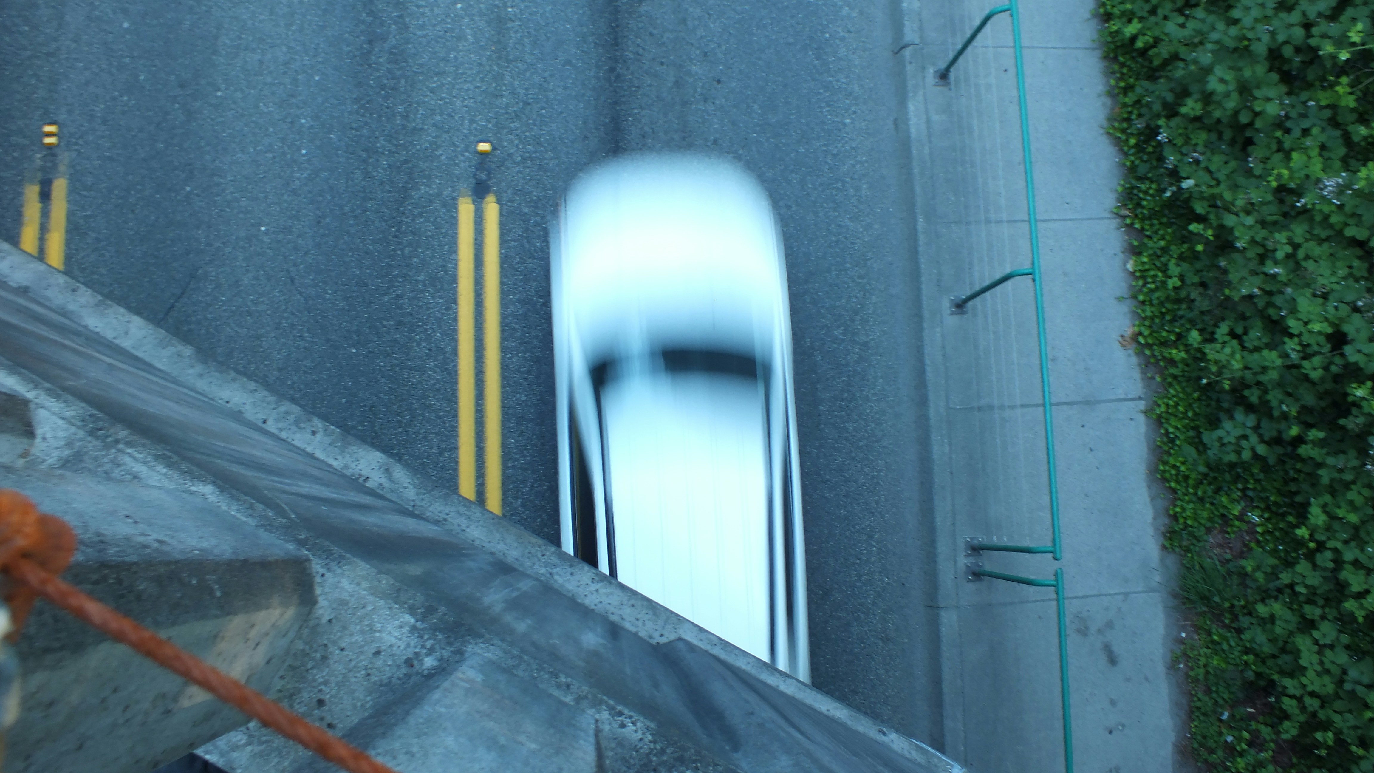 A blurry car drives down a road.