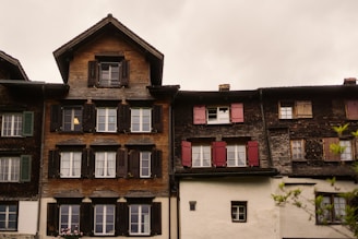 Old european buildings with shuttered windows are shown.
