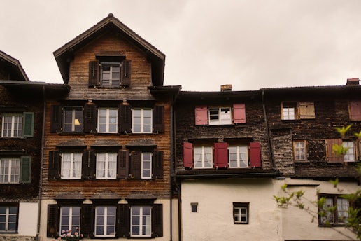 Old european buildings with shuttered windows are shown.