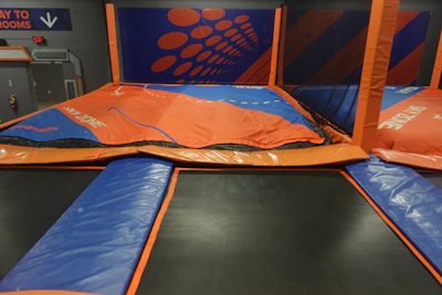 Trampolines at an indoor trampoline park.