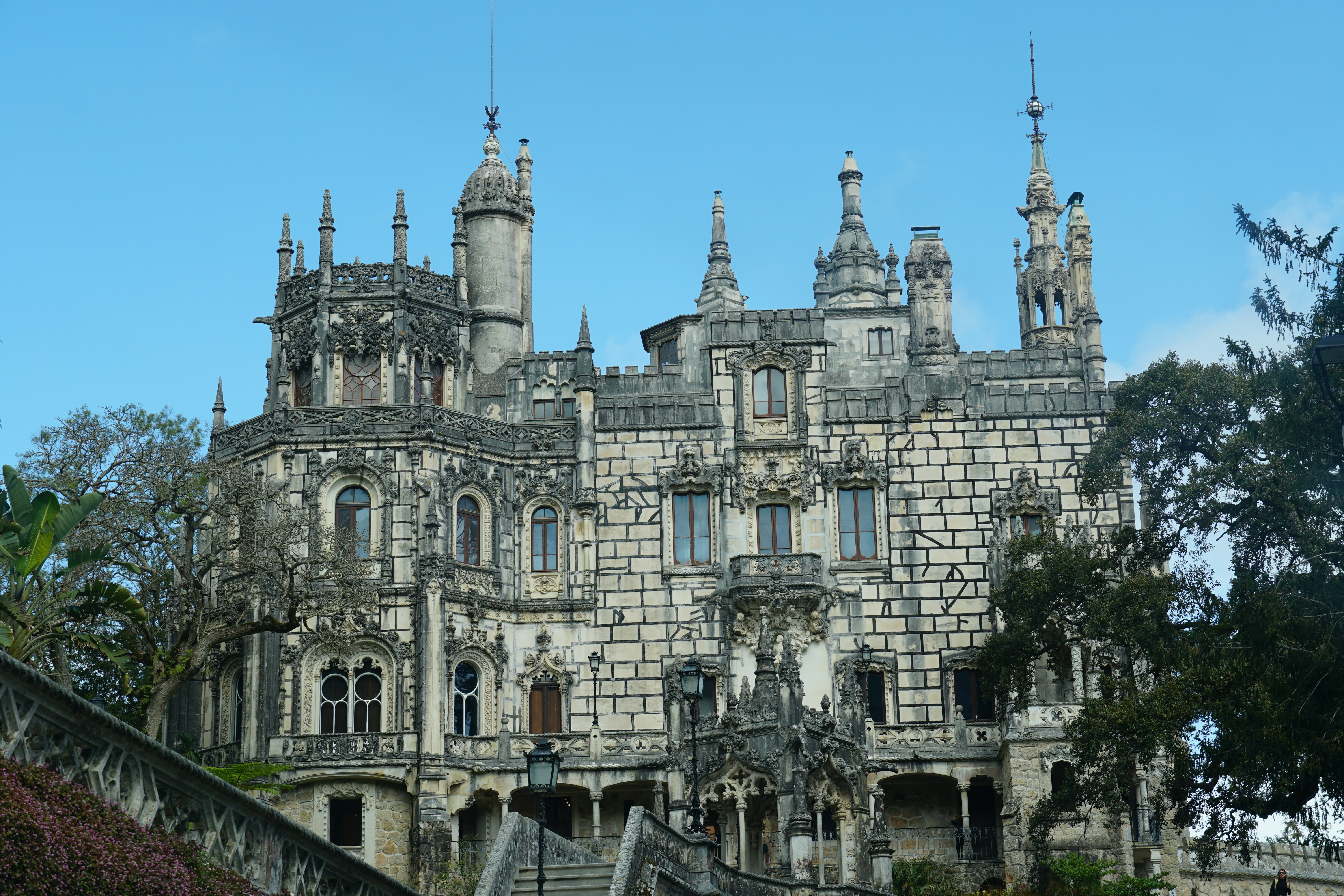 A beautiful castle stands tall against a blue sky.