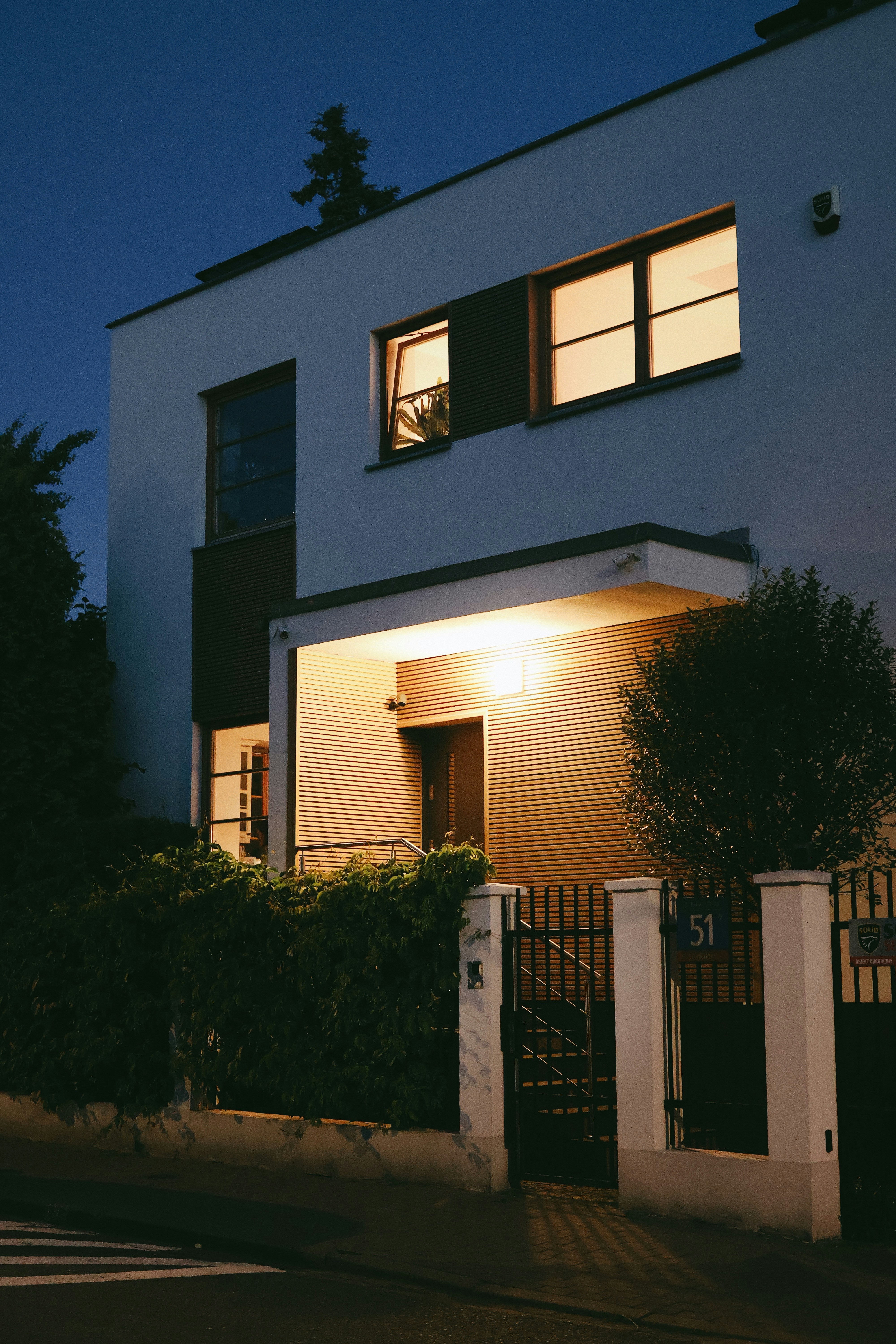 Modern house illuminated at twilight symbolizing prime real estate investment opportunities