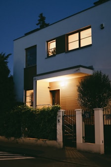A modern house illuminated at twilight.