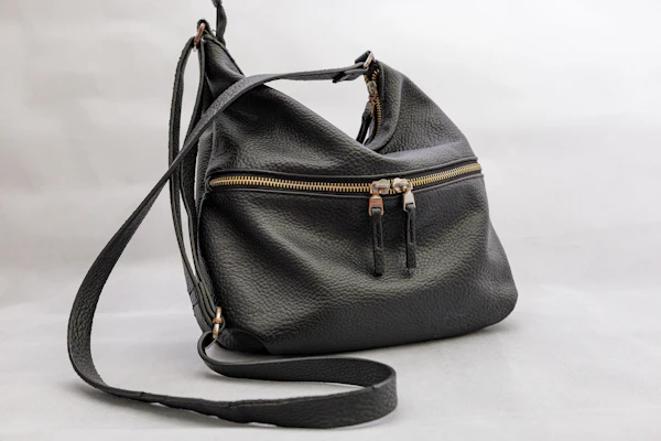 Black leather shoulder bag on display