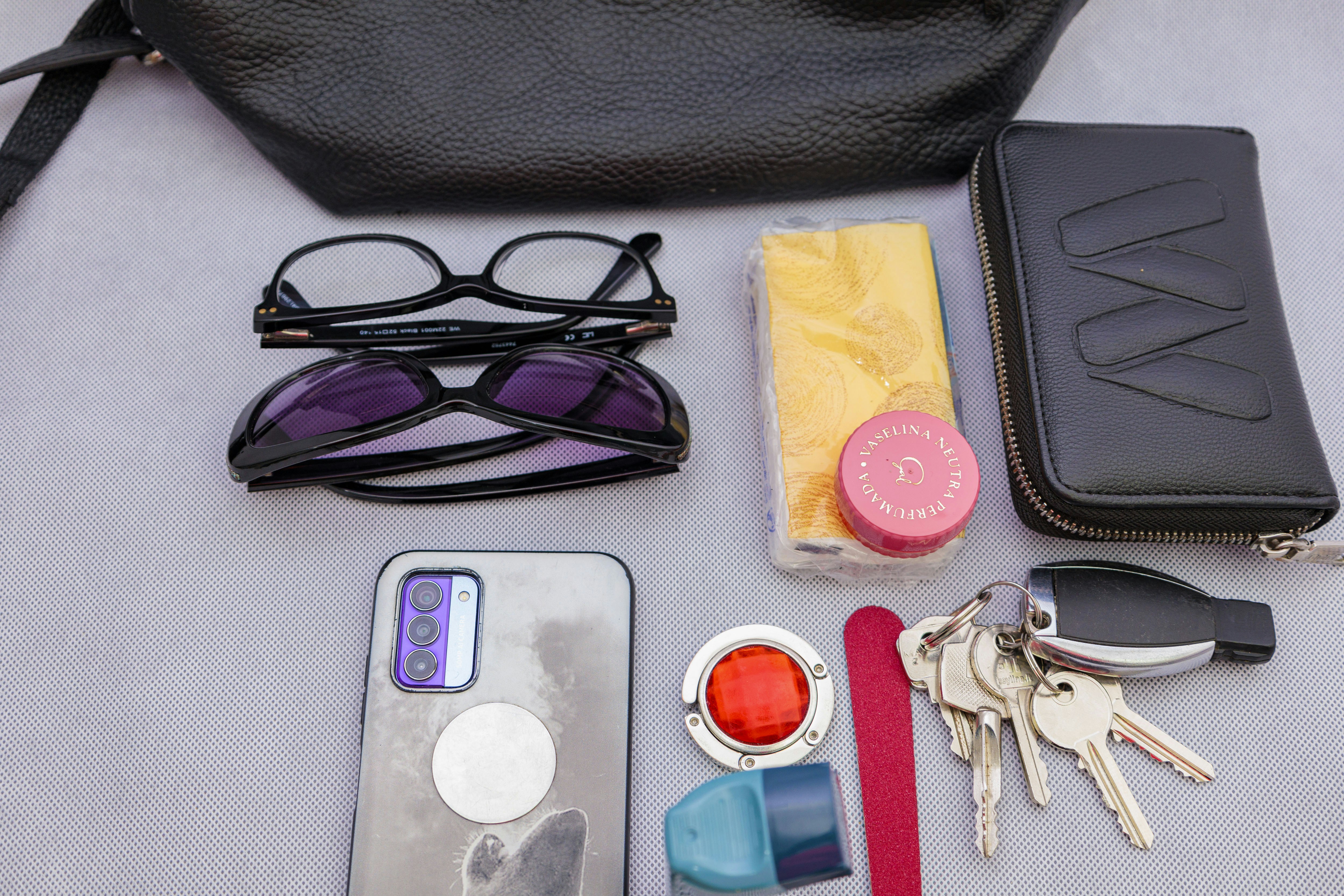 Here's a possible caption: a woman's purse contents are shown.