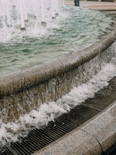 Water flows over a fountain's edge.