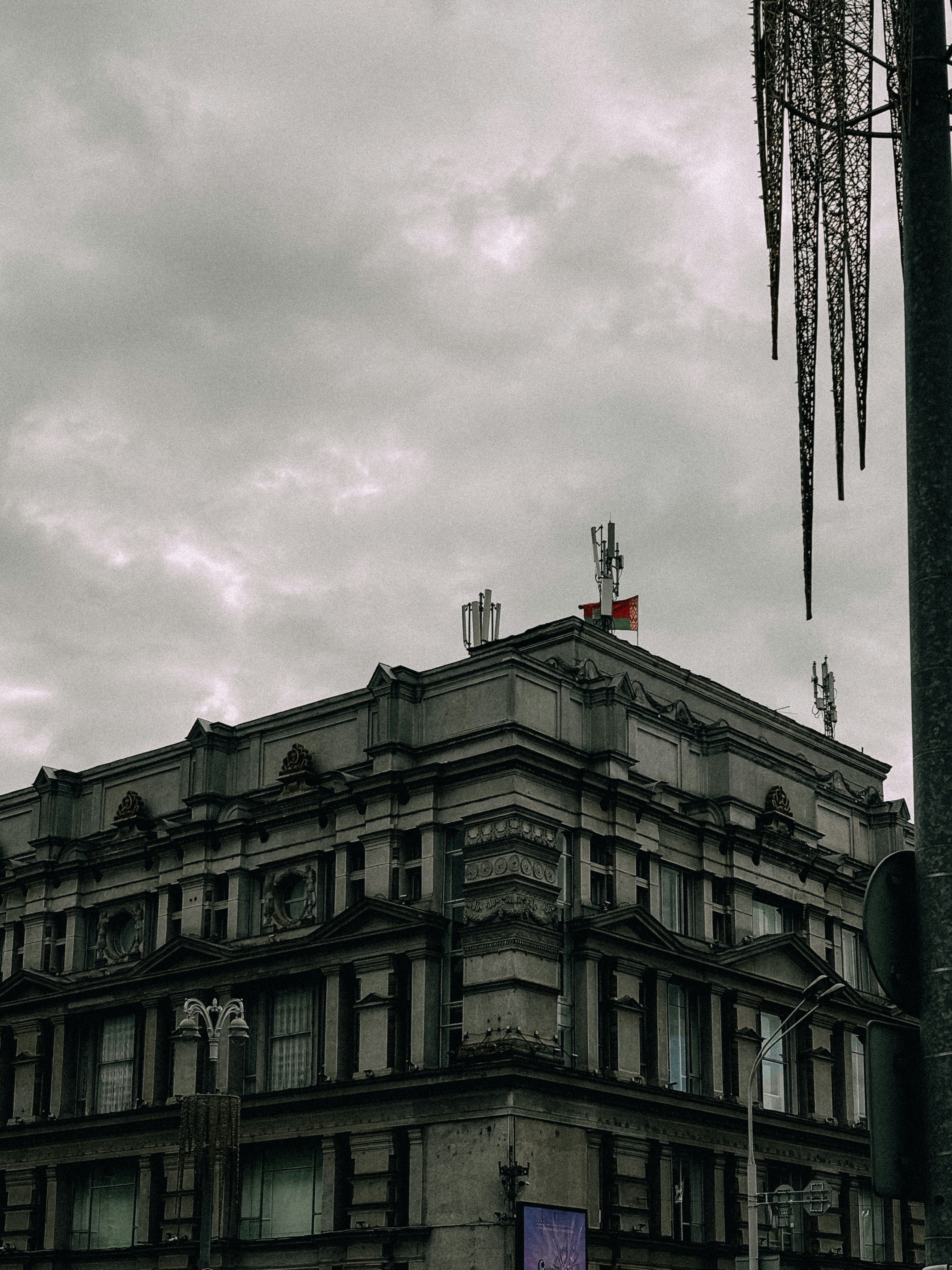 A gray building stands under a cloudy sky.