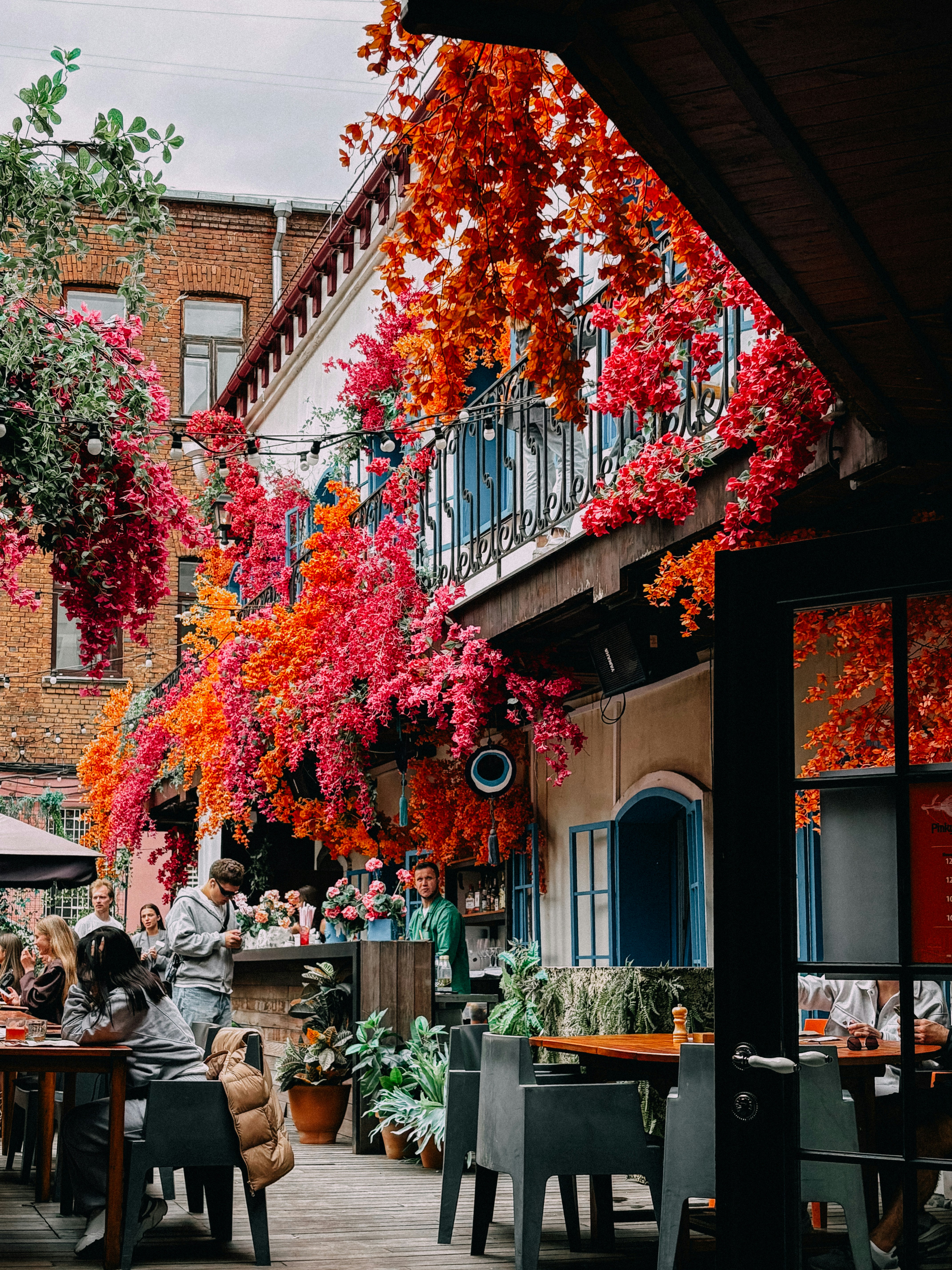 Beautiful restaurant patio overflowing with colorful flowers.