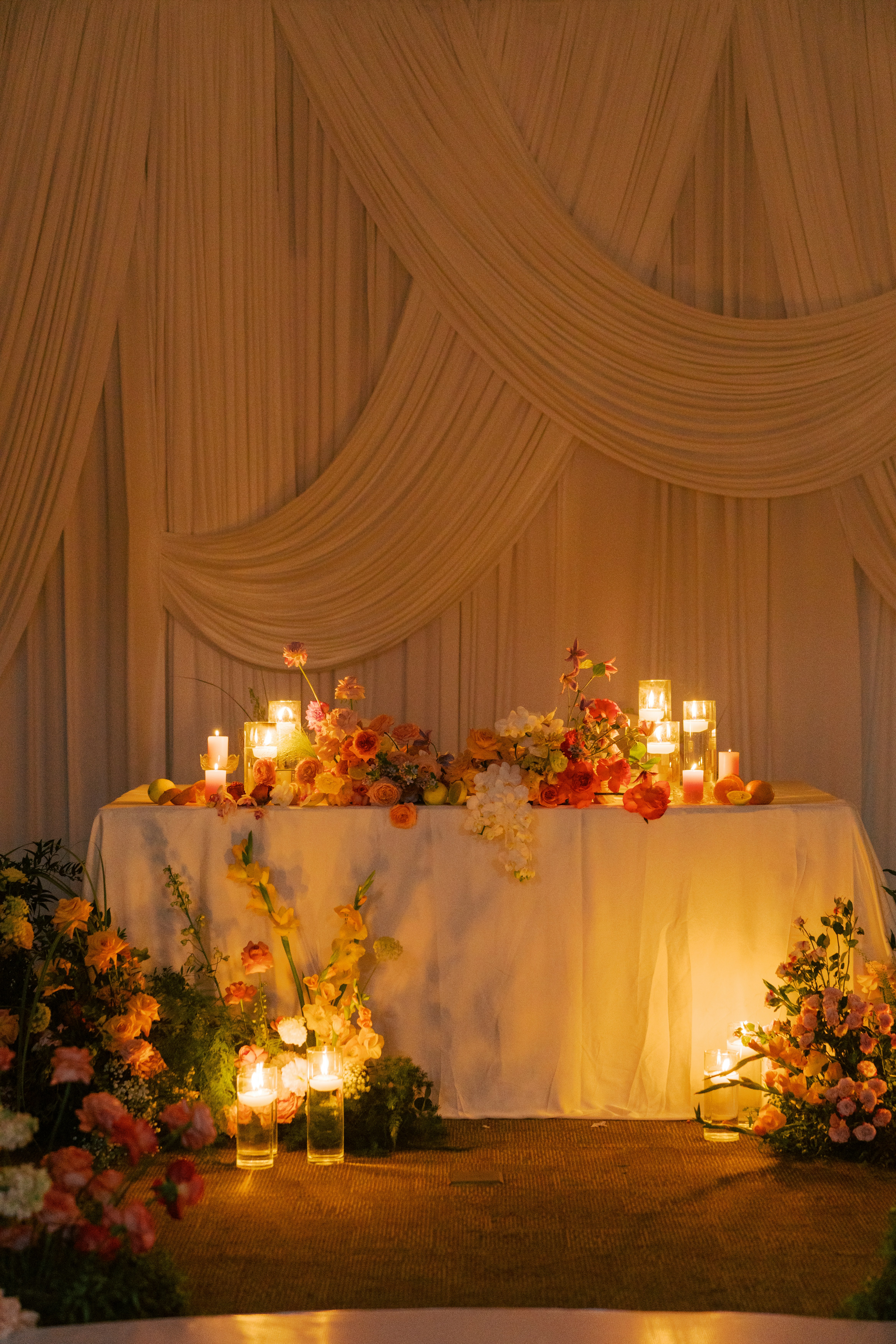 A decorated table with flowers and candles.