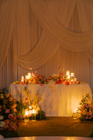 A decorated table with flowers and candles.