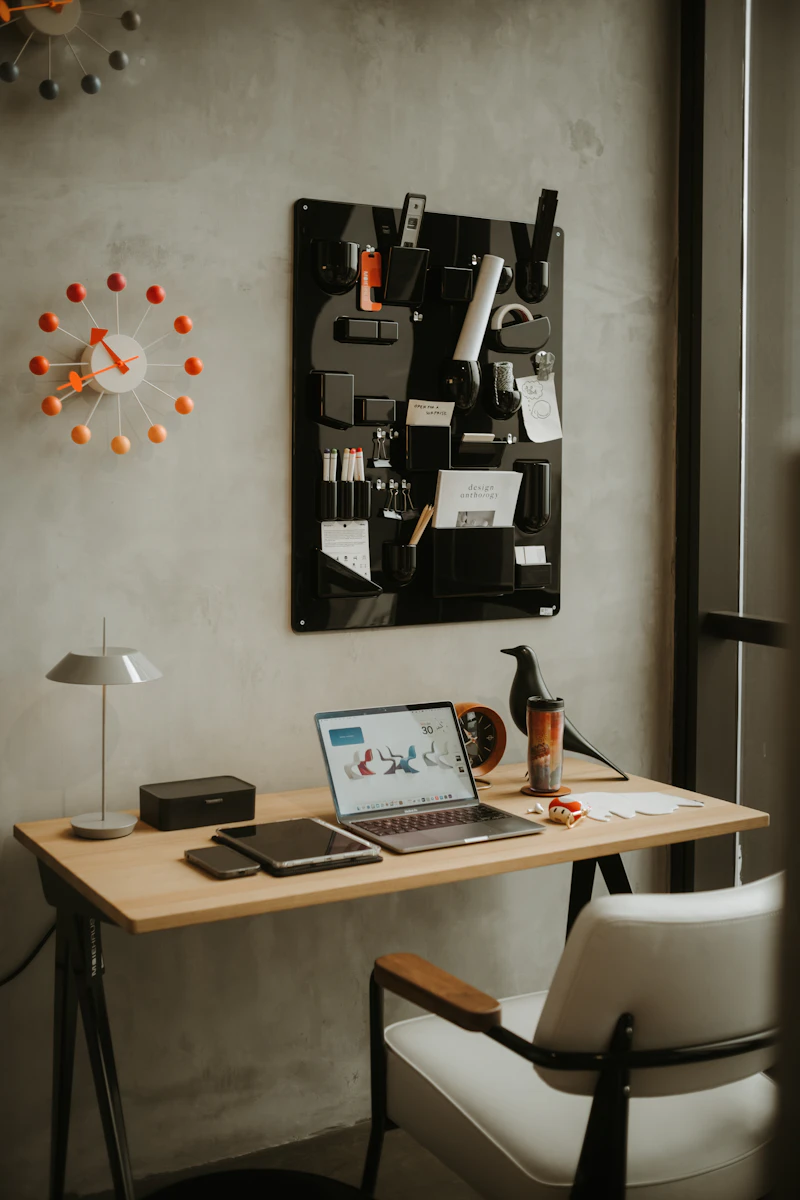 Web design workspace with a laptop showing a website layout