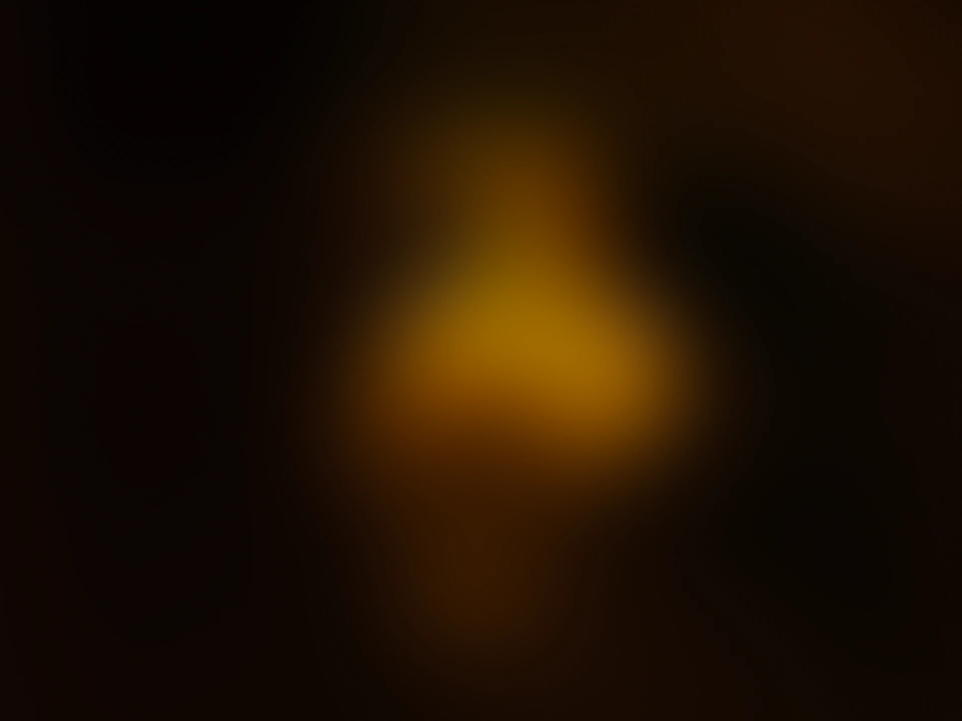 Warm, golden light against a dark background.